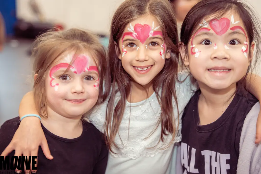 Happy children at MOUVE kids summer camp in London posing for group photo